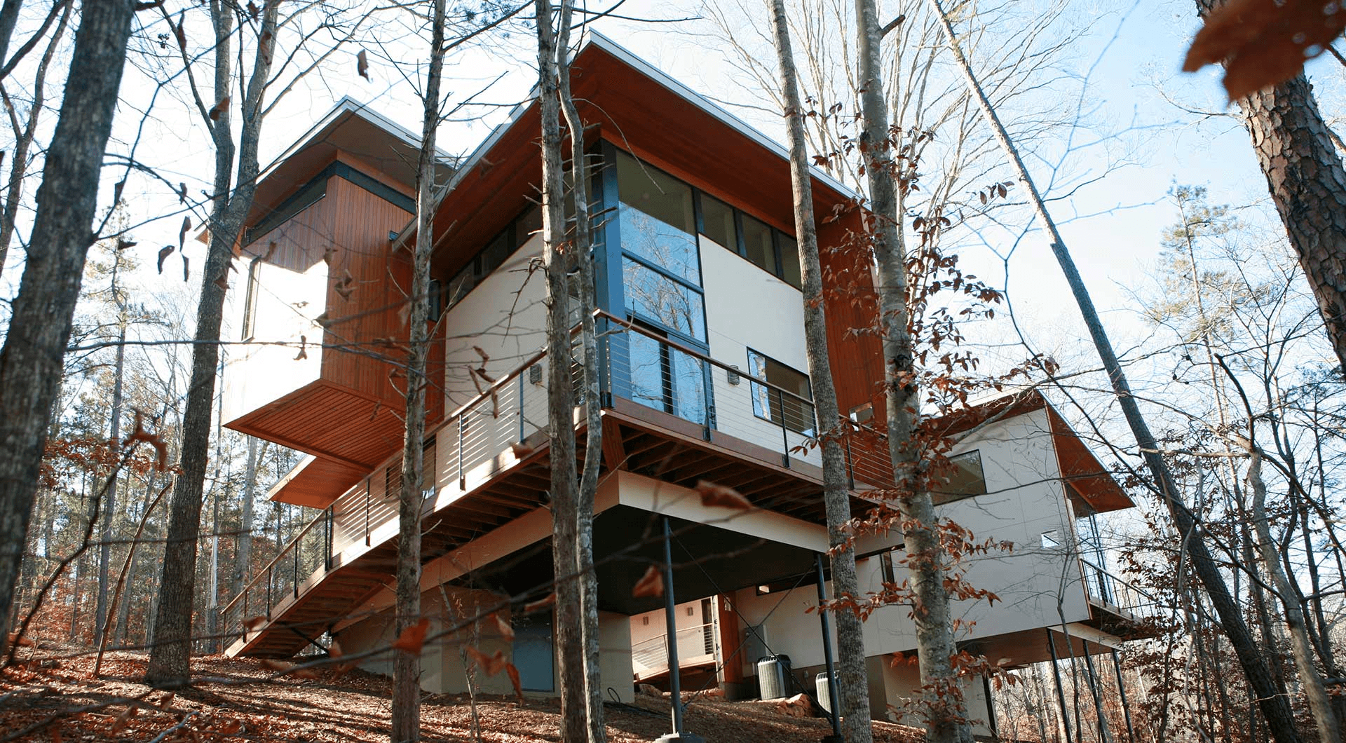a house in the woods surrounded by trees