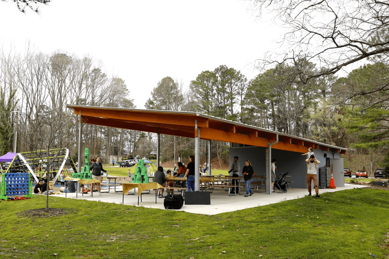 a group of people standing around a picnic area