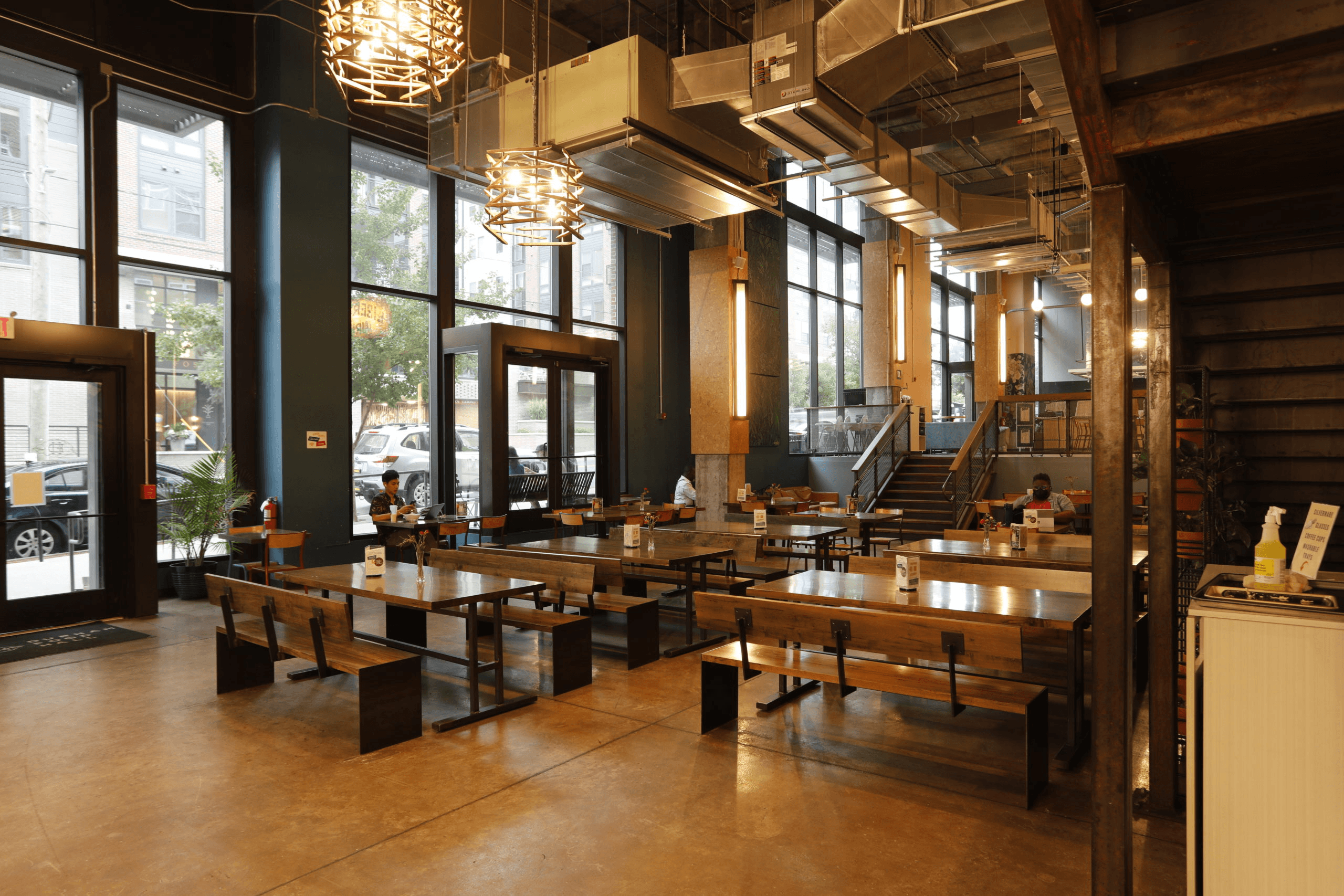 restaurant with tables and benches in front of large windows