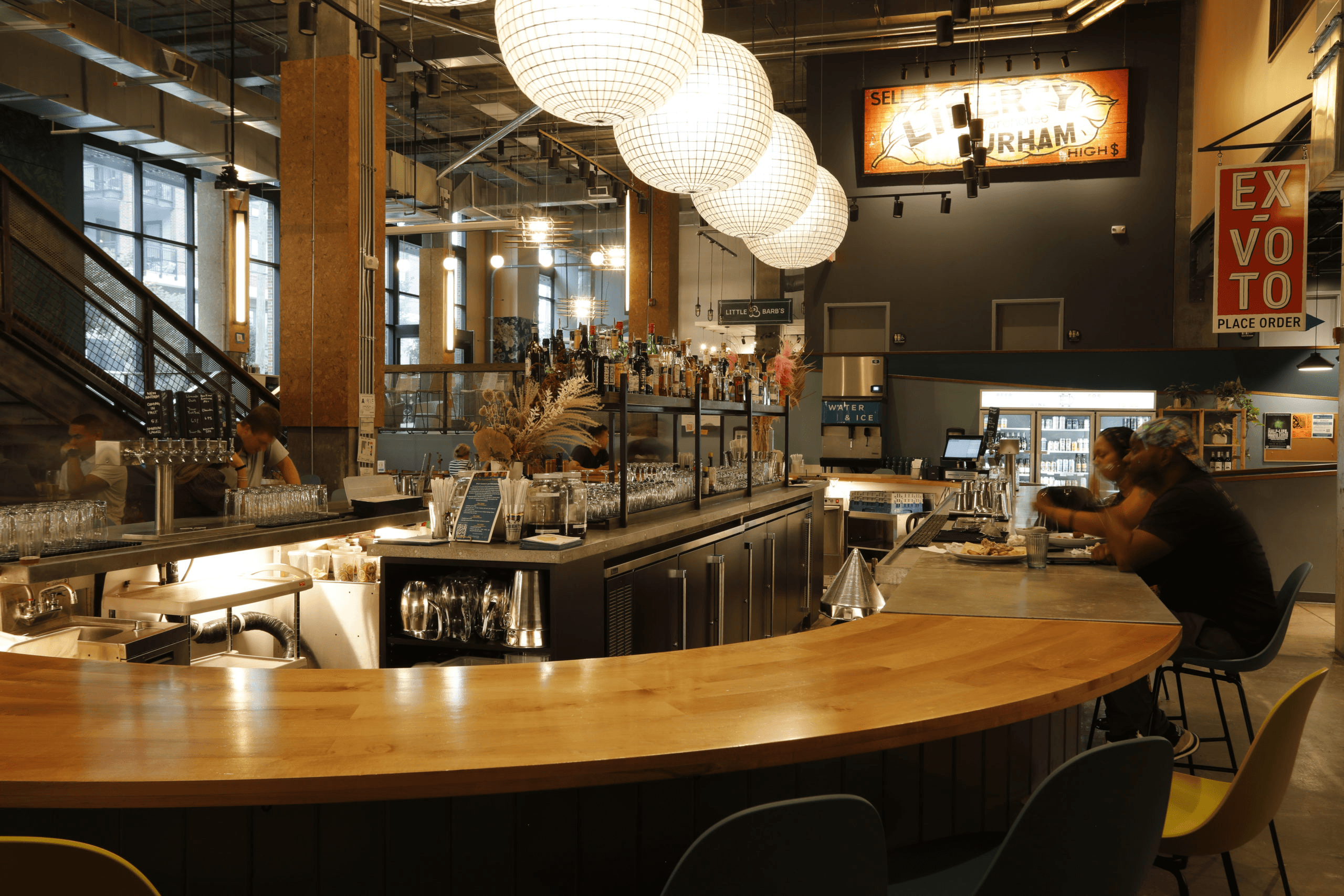 a man sitting at a bar in a restaurant