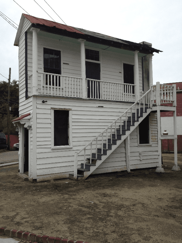 a white house with a staircase going up