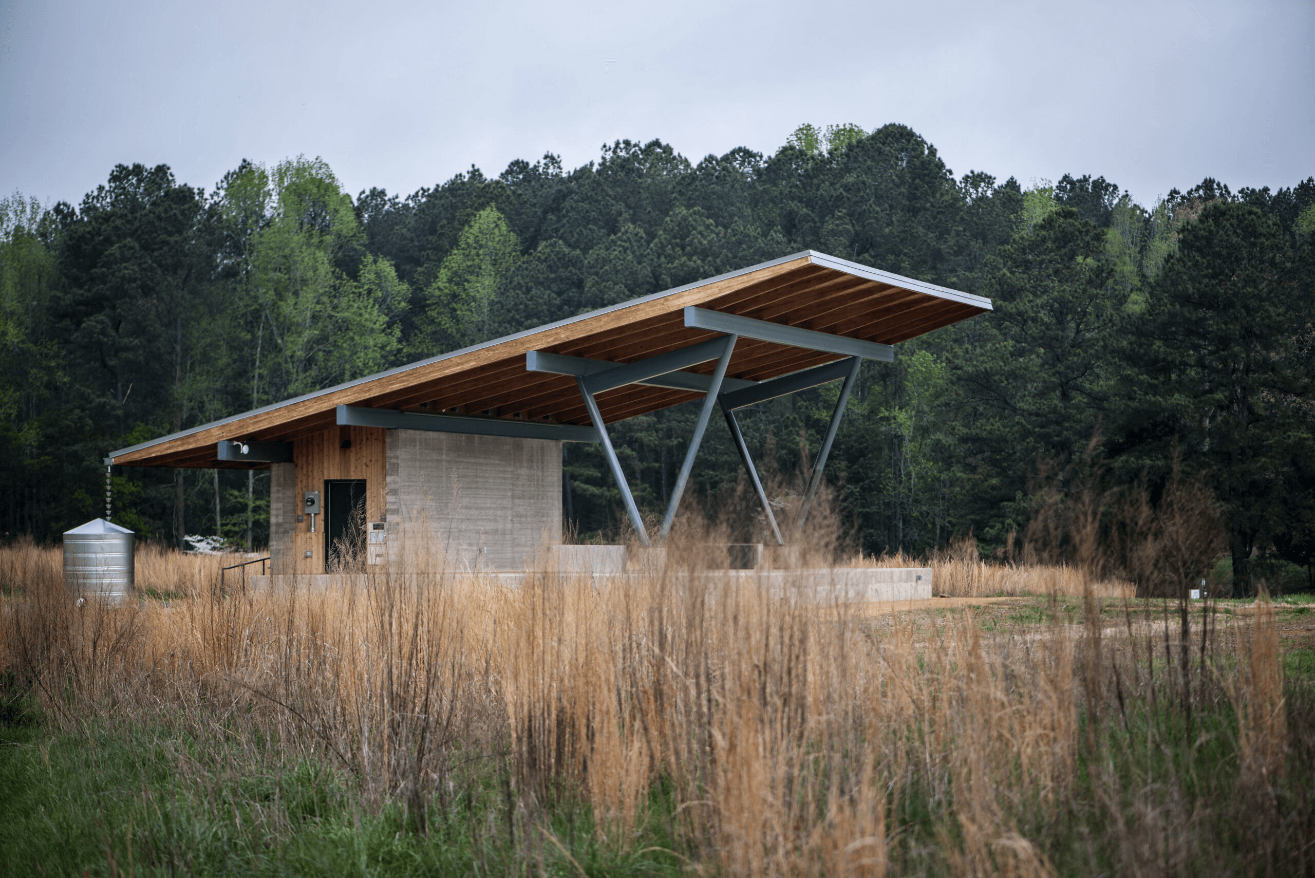 a small brown shelter in a brown field